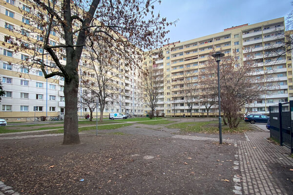 Auf dem Bild ist ein Wohninnenhof vor Hochhäusern an der Budapester Straße zu sehen.